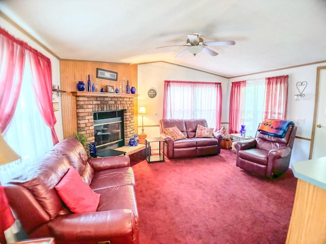 living room featuring lofted ceiling, a brick fireplace, ceiling fan, and carpet flooring