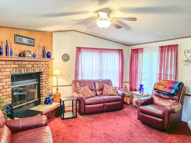 carpeted living area with vaulted ceiling, a textured ceiling, a fireplace, and crown molding