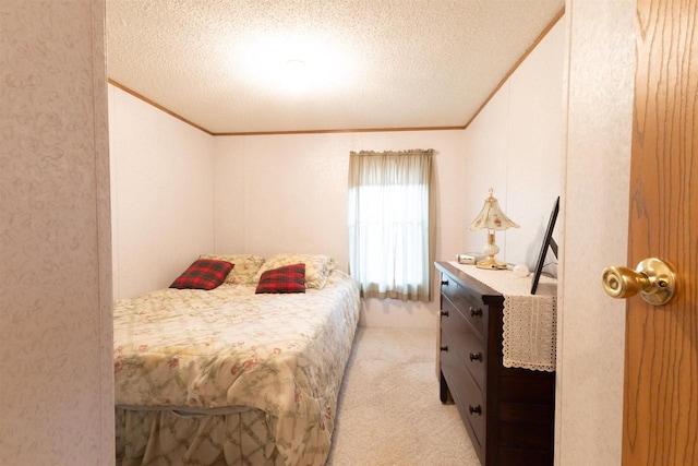 bedroom with a textured ceiling and light colored carpet