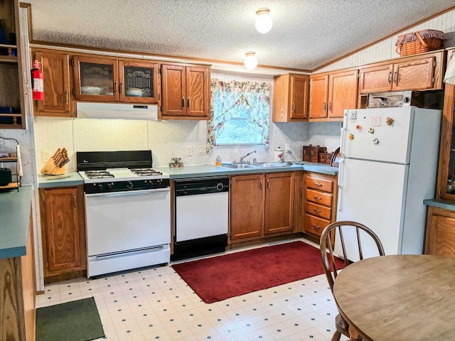 kitchen with white appliances, under cabinet range hood, brown cabinetry, and light floors