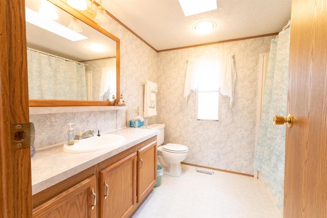 bathroom with tile patterned flooring, vanity, toilet, and a textured ceiling