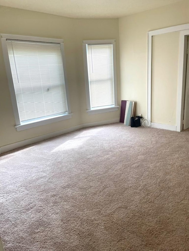 spare room with light colored carpet