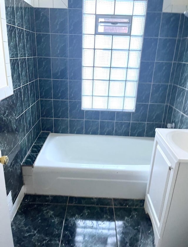 bathroom featuring tile patterned flooring, vanity, separate shower and tub, and tile walls