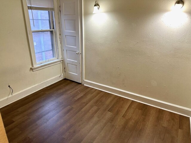 empty room featuring dark hardwood / wood-style flooring