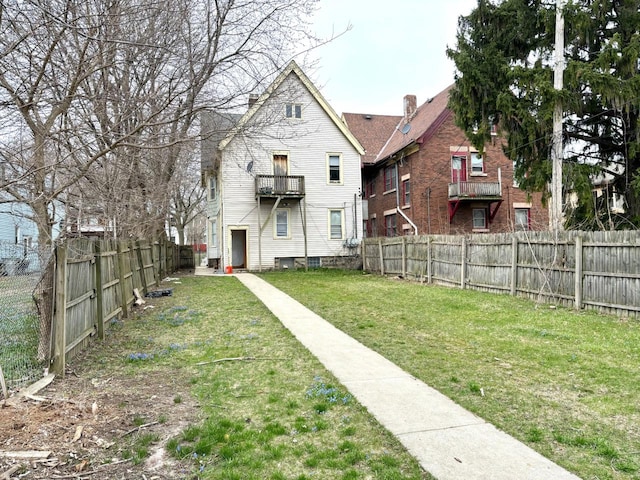 view of yard with a balcony