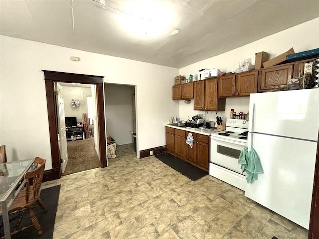 kitchen with white appliances and light tile patterned floors