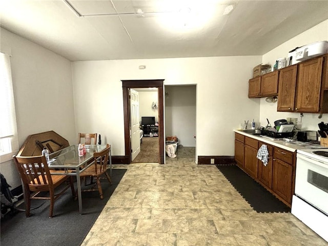 kitchen featuring electric stove and carpet flooring