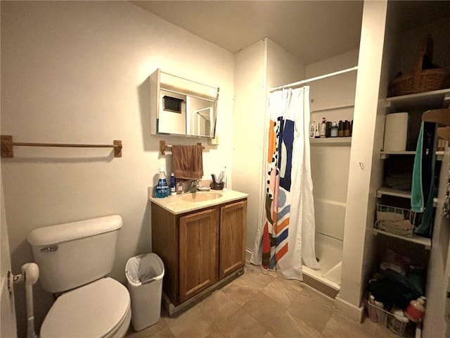 bathroom featuring tile patterned floors, a shower with curtain, toilet, and vanity