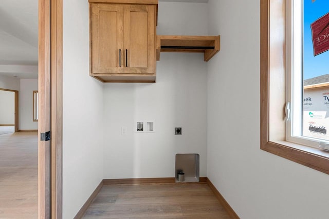 washroom featuring cabinets, hookup for an electric dryer, hookup for a washing machine, and light wood-type flooring