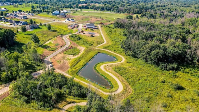 aerial view featuring a water view and a forest view