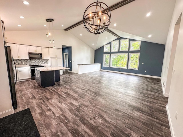 kitchen featuring hanging light fixtures, a center island, refrigerator, dark wood-type flooring, and beam ceiling