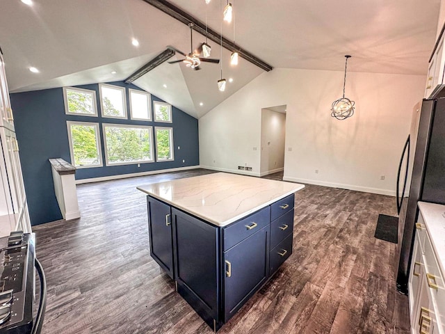 kitchen featuring light stone countertops, a center island, dark hardwood / wood-style floors, and stainless steel refrigerator