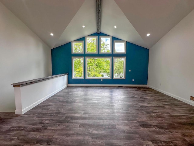 interior space with lofted ceiling with beams and dark wood-type flooring