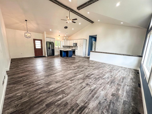 unfurnished living room featuring dark wood-type flooring, ceiling fan with notable chandelier, high vaulted ceiling, and beam ceiling