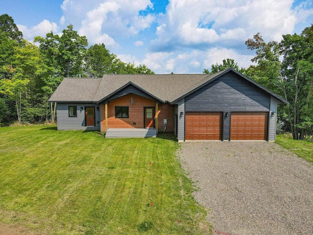 ranch-style house featuring a front yard and a garage