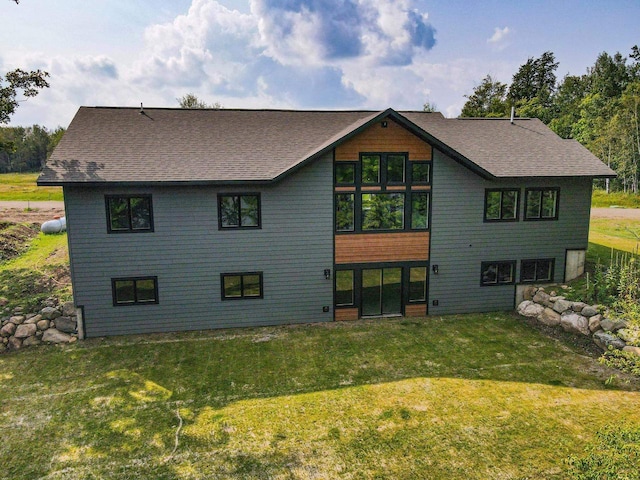 rear view of house with a yard