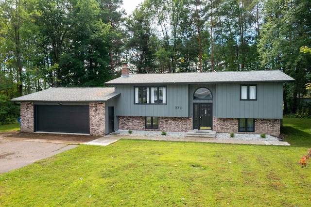 view of front of property with a garage and a front lawn