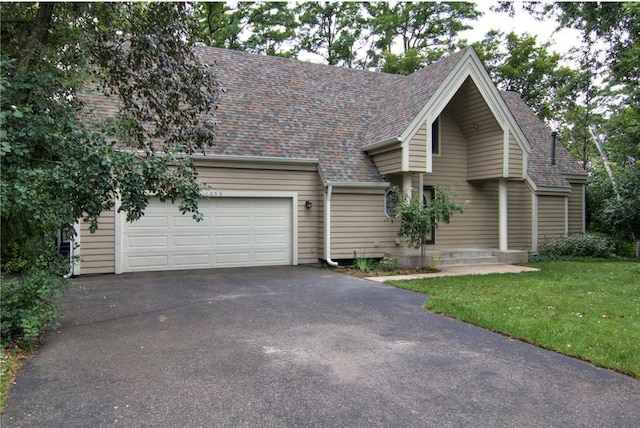 view of front of home with a garage and a front yard