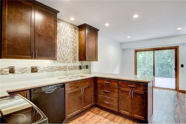 kitchen with dishwasher, backsplash, light hardwood / wood-style floors, kitchen peninsula, and sink