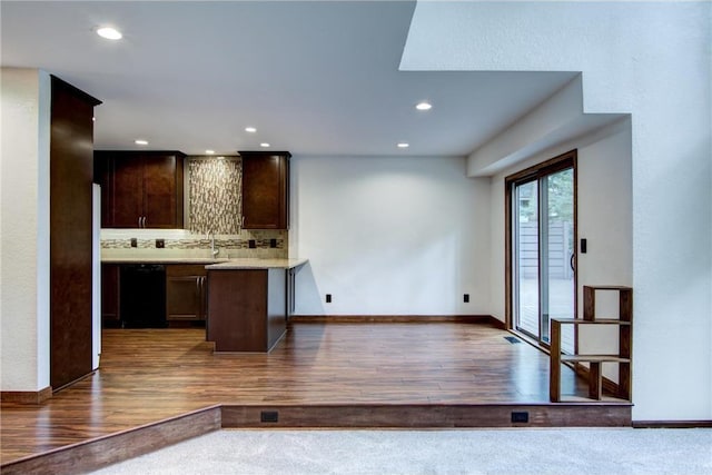 kitchen with sink, dark hardwood / wood-style floors, black dishwasher, decorative backsplash, and dark brown cabinetry