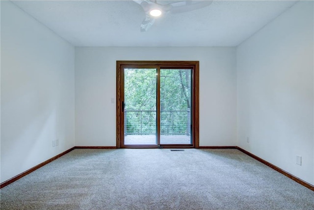 empty room with ceiling fan and carpet