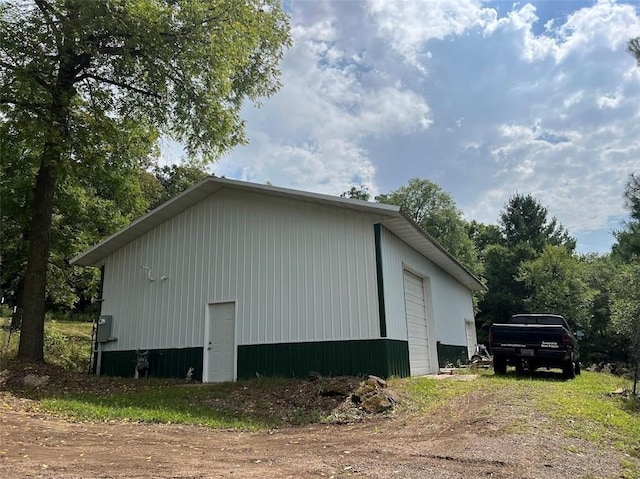 view of property exterior with a garage and an outdoor structure