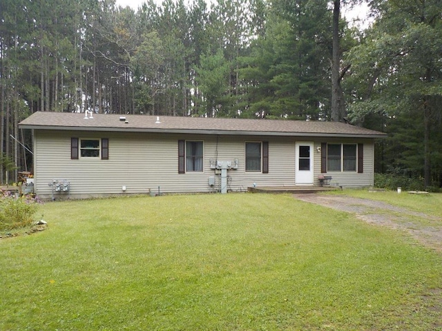 single story home with driveway and a front lawn