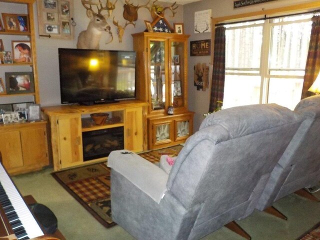 carpeted living room featuring a fireplace