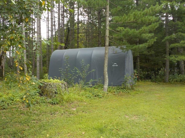 view of outdoor structure with a lawn