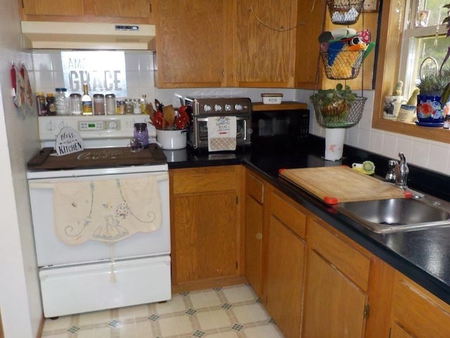 kitchen featuring white range with electric stovetop, decorative backsplash, and sink