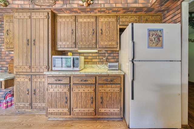 kitchen with hardwood / wood-style floors and white appliances