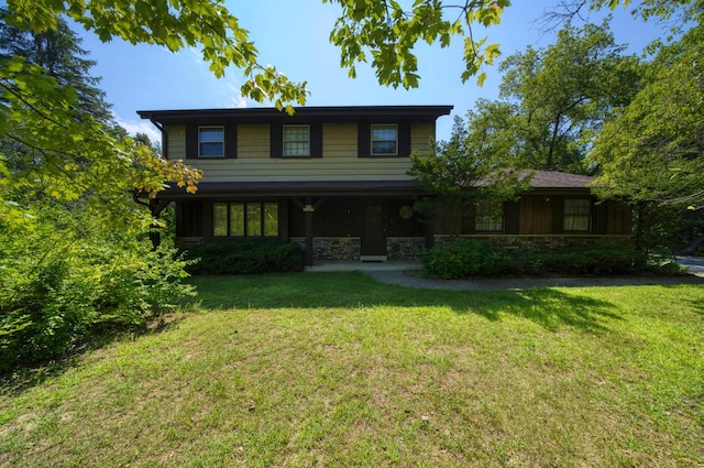 rear view of property featuring a yard