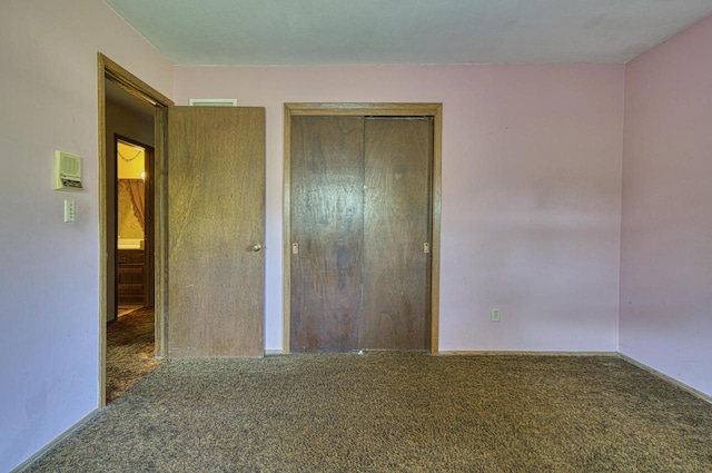 unfurnished bedroom with carpet and a closet