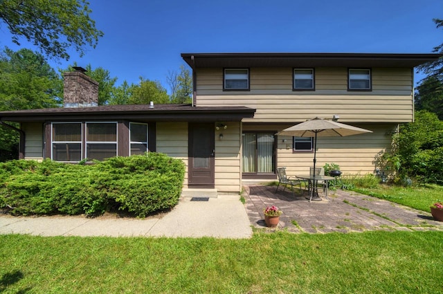 front facade featuring a patio area and a front yard