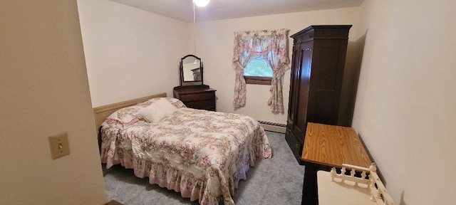 carpeted bedroom with a baseboard heating unit