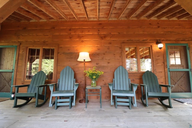 unfurnished room featuring wooden walls