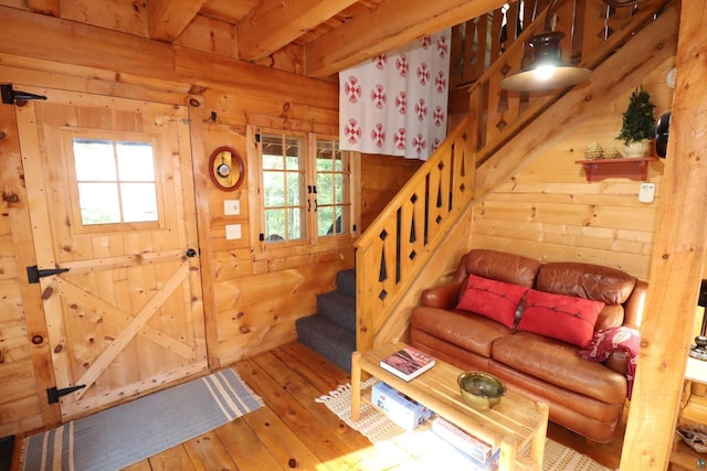 interior space with light wood-type flooring and beam ceiling