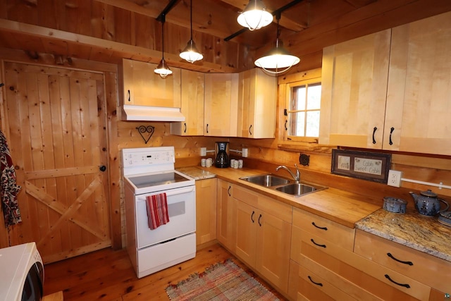 kitchen with decorative light fixtures, white appliances, light hardwood / wood-style flooring, light brown cabinetry, and sink