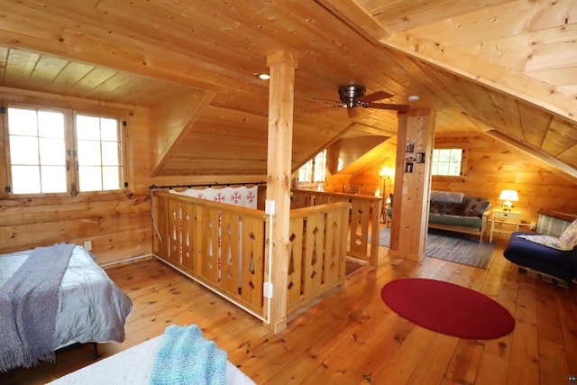 bedroom with wood walls, hardwood / wood-style flooring, wooden ceiling, and vaulted ceiling