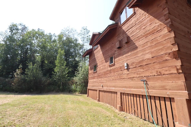 view of property exterior with a yard