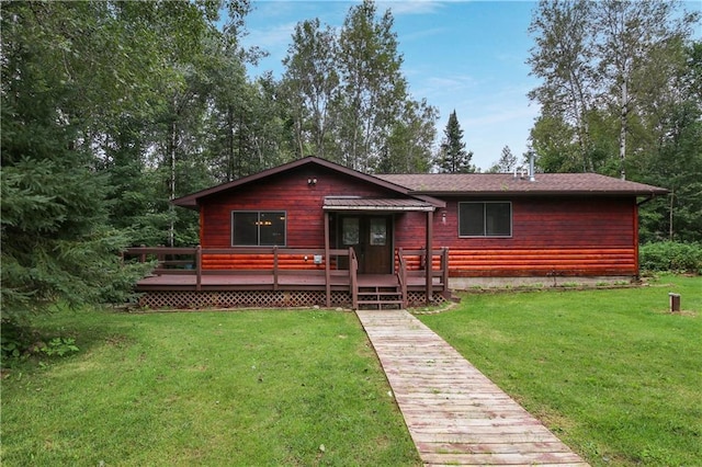 view of front of house with a front yard and a deck