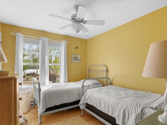 bedroom with ceiling fan and light hardwood / wood-style floors