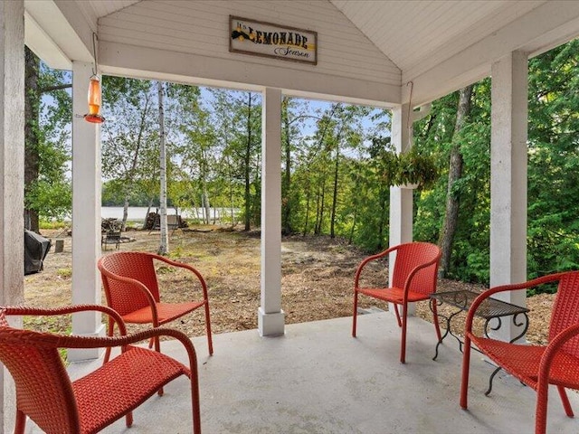 sunroom / solarium with a healthy amount of sunlight, vaulted ceiling, and wooden ceiling