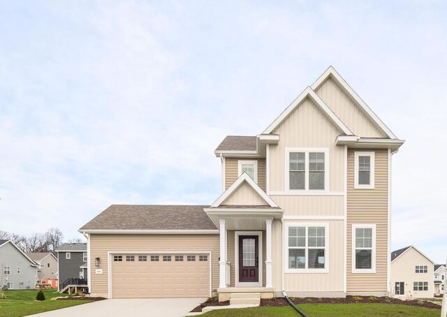 craftsman-style house with a front lawn and a garage