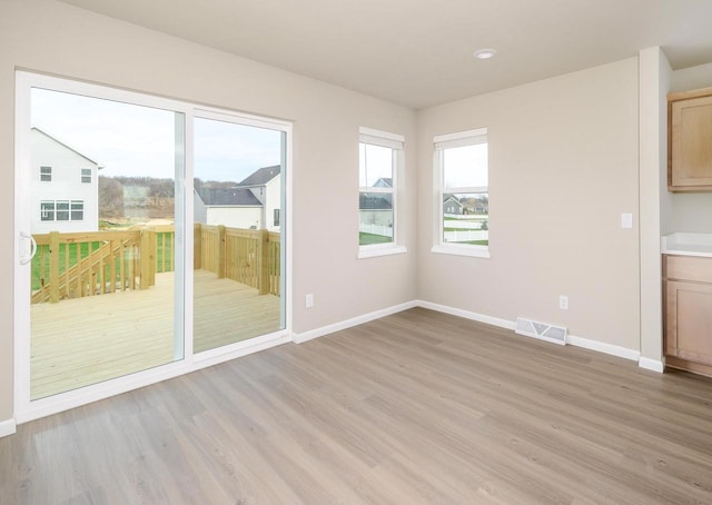 unfurnished dining area featuring light hardwood / wood-style flooring