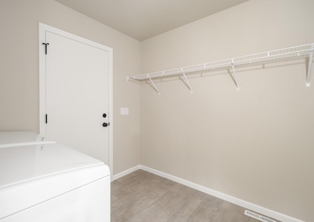 laundry room featuring washer / clothes dryer and light hardwood / wood-style floors