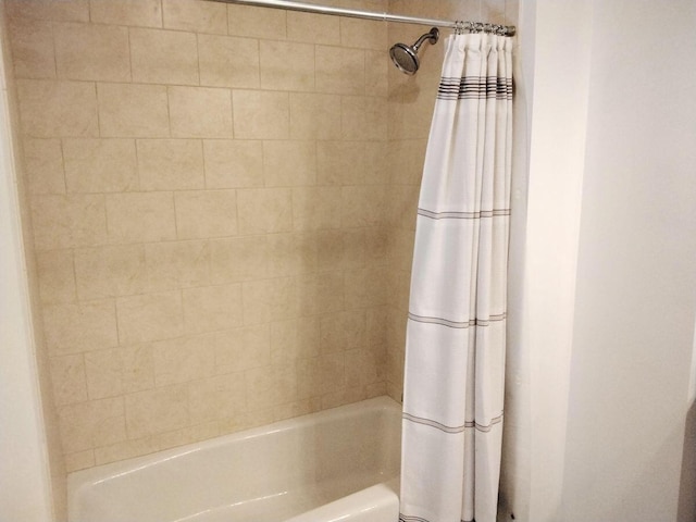 bathroom featuring shower / tub combo with curtain