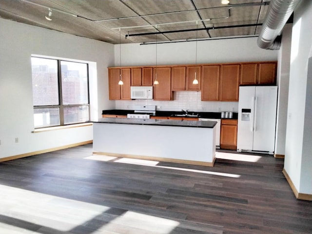 kitchen with dark hardwood / wood-style floors, sink, decorative light fixtures, and white appliances