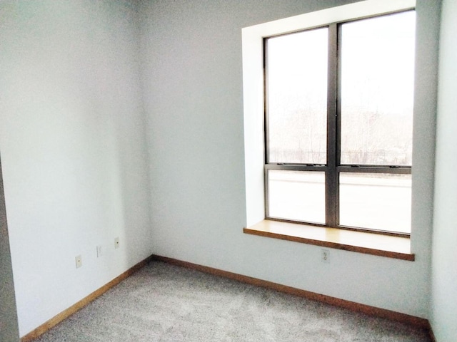 carpeted spare room featuring a wealth of natural light