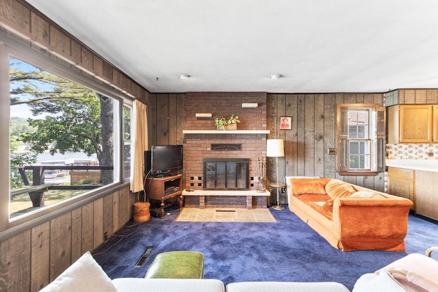 W11585 Demynck Rd, Lodi, WI 53555 - carpeted living room with a brick fireplace and wooden walls